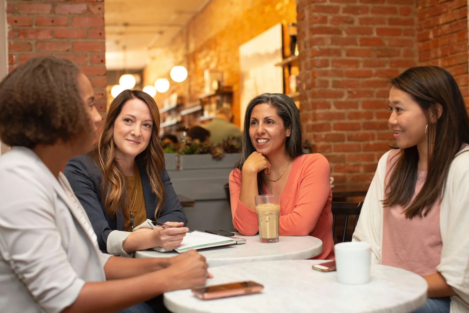A small group in conversation around a cafe table